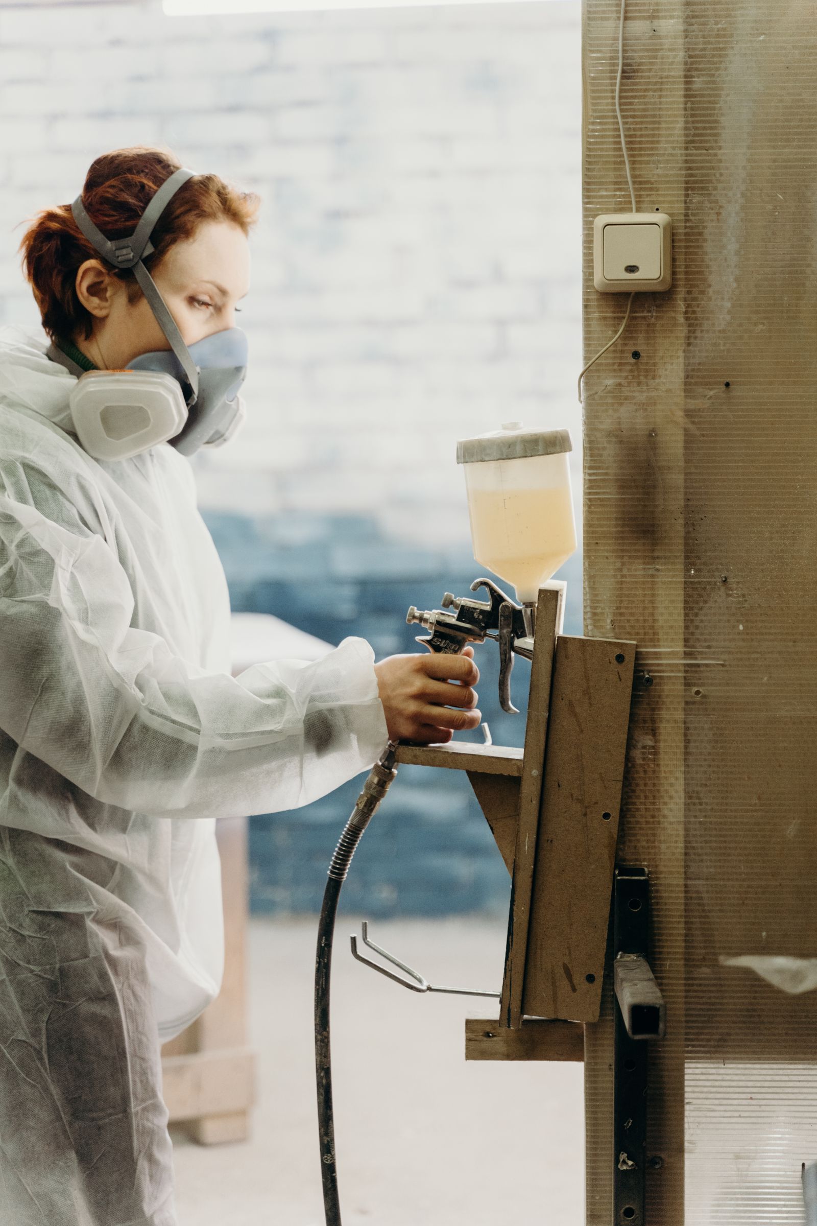 spraying cabinet doors in a finishing shop